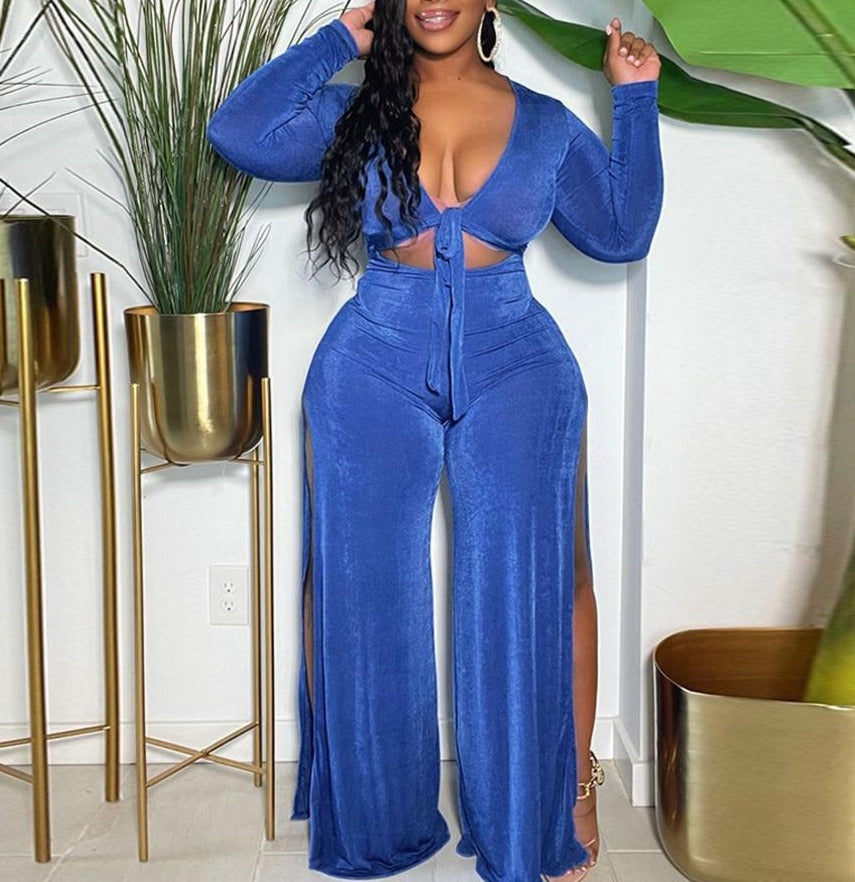 A 2-Piece Classy Tracksuit perfect for fall, featuring a long sleeve top and wide-leg pants. Trendy, classy, and sexy with a plunging neckline and slits on both sides of the pants. Available in blue and pink and in different sizes to fit you perfectly. Ideal for dates, parties, and other casual occasions. Switch up your style this fall and get yours now!