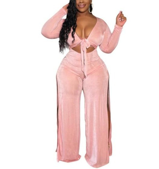 A 2-Piece Classy Tracksuit perfect for fall, featuring a long sleeve top and wide-leg pants. Trendy, classy, and sexy with a plunging neckline and slits on both sides of the pants. Available in blue and pink and in different sizes to fit you perfectly. Ideal for dates, parties, and other casual occasions. Switch up your style this fall and get yours now!