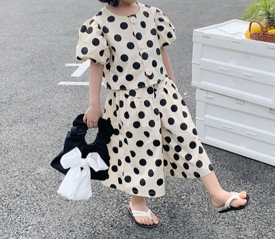 Image of Polka Dots Summer Casual Set - Stylish and comfortable summer outfit for little girls. Includes a short sleeve blouse and square pants. Adorned with playful polka dots. Available in various sizes. Machine washable for easy cleaning. Perfect for your little one's summer wardrobe!